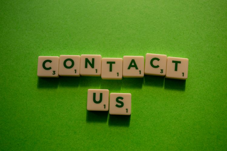 How Much Does Supervised In-The-Community Contact Cost? image of scrabble tiles on green background.